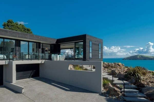 Contemporary house with expansive glass windows and clean lines, showcasing attention to detail and quality craftsmanship.