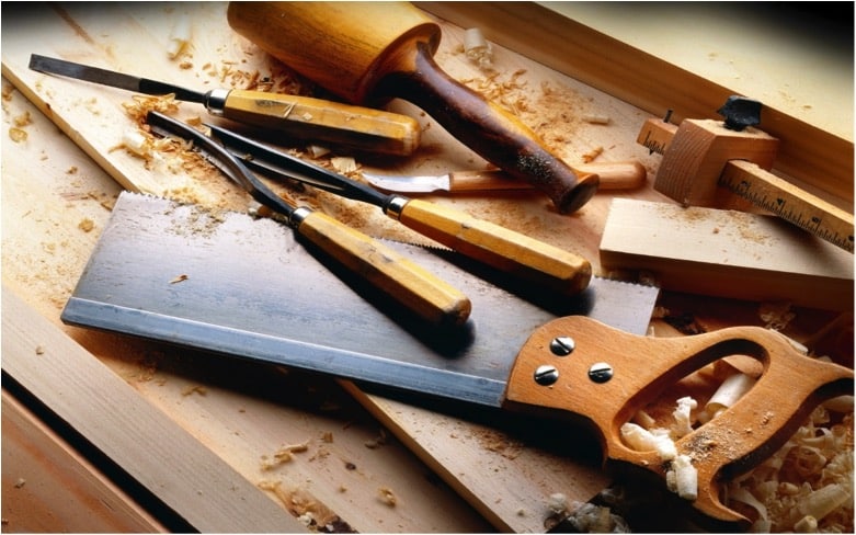 Woodworking tools on timber planks, symbolising the craftsmanship and materials used in building a dream home