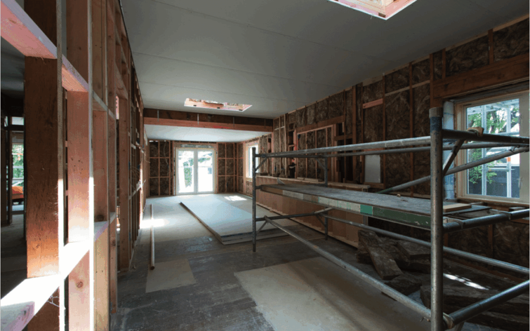 Interior of a home during renovation, showing exposed framing and insulation, symbolising transformation potential