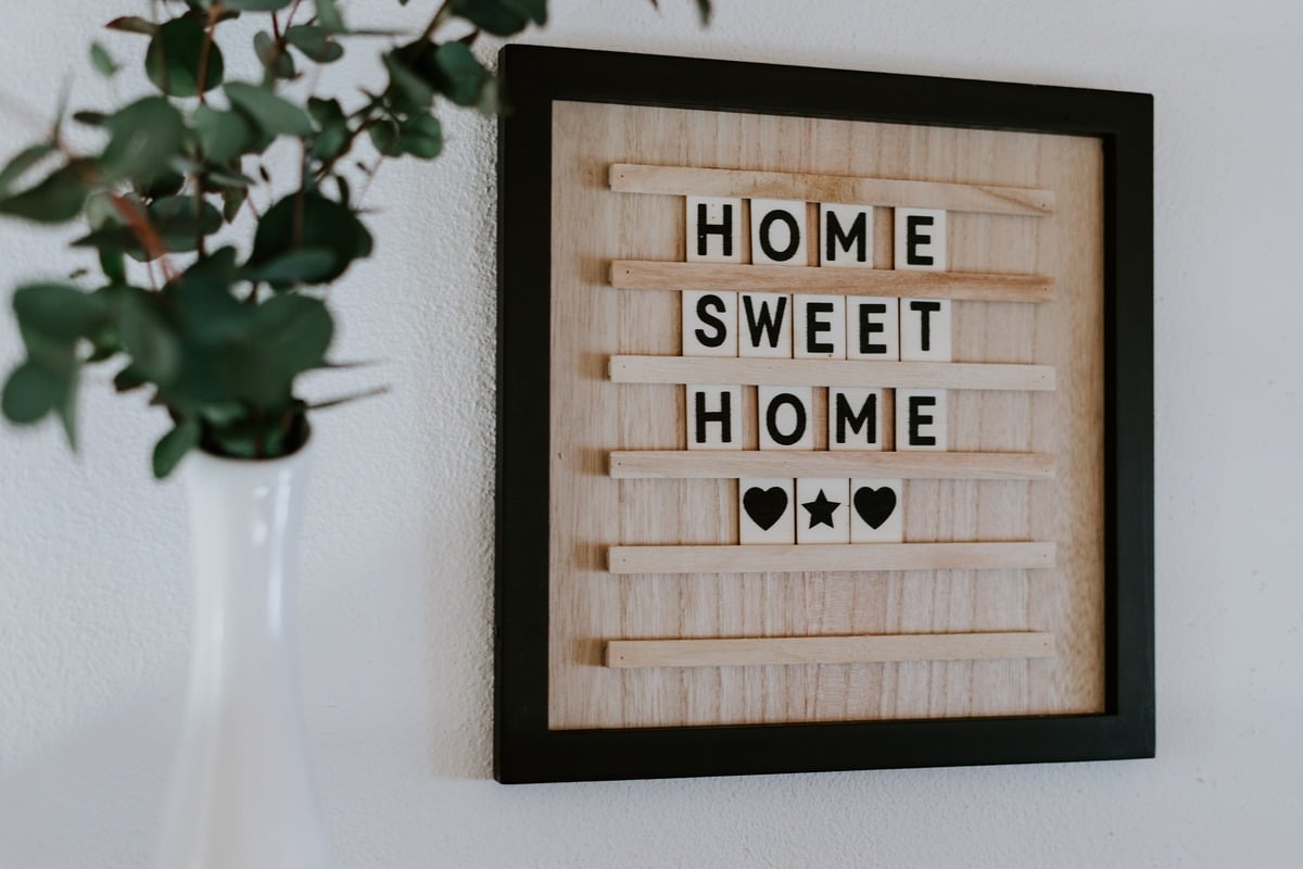 Image of 'Home Sweet Home' sign, associated with answers to common new home building questions.